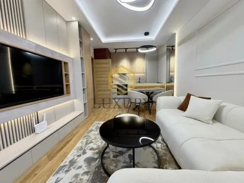 Modern living room with a sofa set and a dining area in the background. - image 2