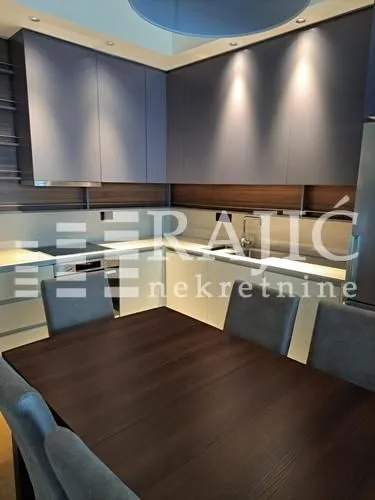 Modern kitchen with a dining table and chairs.