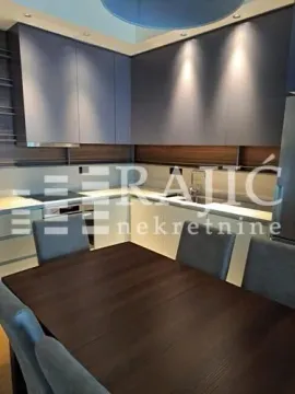 Modern kitchen with a dining table and chairs. - image 7