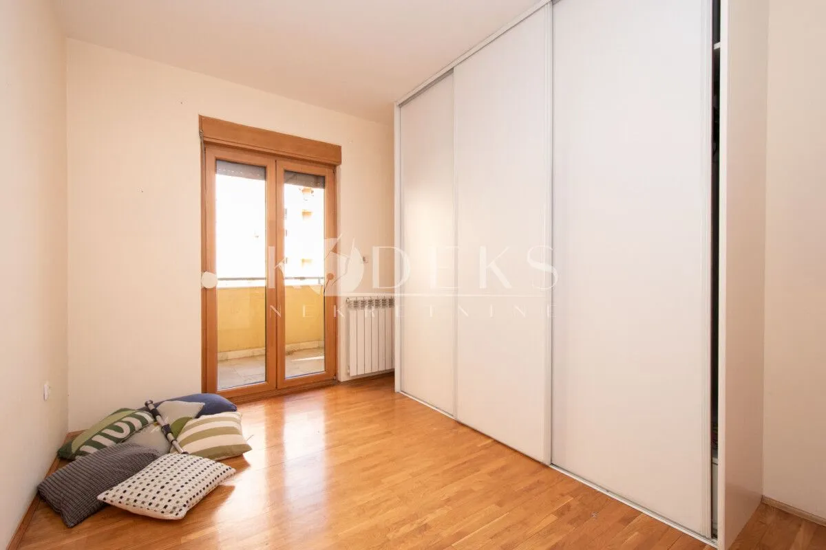Small bedroom with a large built-in wardrobe and access to the terrace.