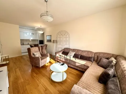 Spacious living room with a sofa set and a dining area in the background. - image 2