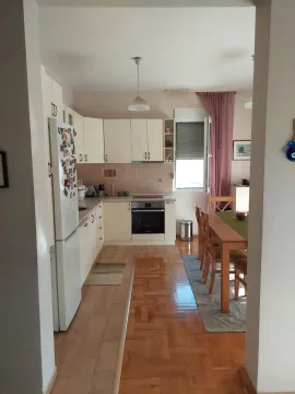 Kitchen with a dining area in an open-plan space. - image 12