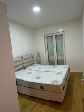 Bedroom with a double bed and balcony access. - image 7