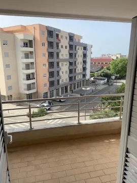 View from the balcony towards the neighboring building and street. - image 13