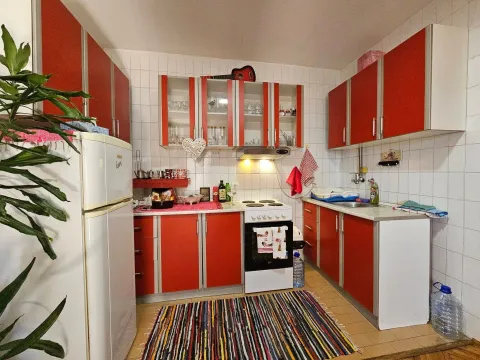 Small kitchen with red cabinets and white appliances. - image 4