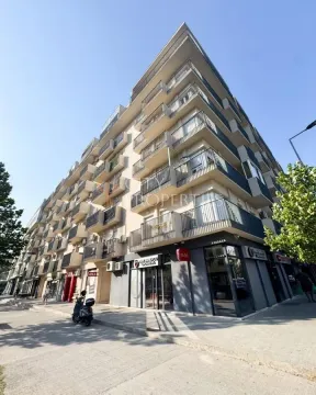 Spoljašnji izgled moderne stambene zgrade sa lokalima u prizemlju i balkonima. - image 2
