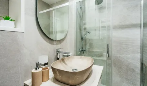 Modern bathroom with a washbasin and a shower cabin. - image 10