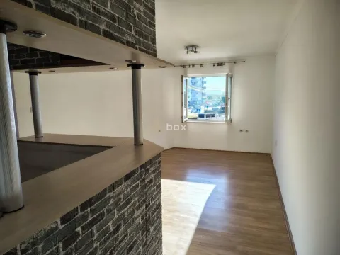 Empty living room with a brick bar counter and a view through the window. - image 4