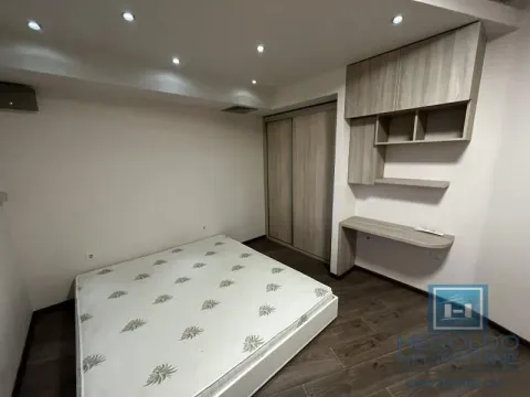 Furnished bedroom with a double bed, wardrobe, and desk. - image 12