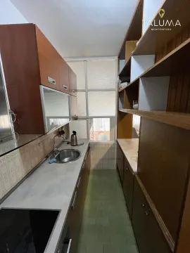 Smaller kitchen with wooden elements and a sink. - image 5