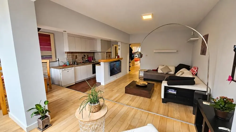 Open-plan living room with kitchen and dining area.