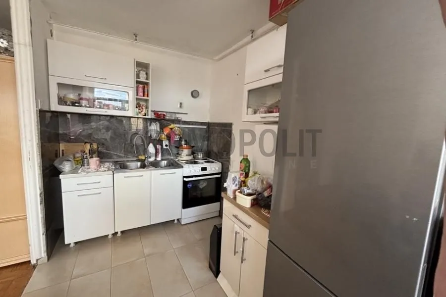 Smaller kitchen with white cabinets and a stove.