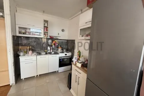 Smaller kitchen with white cabinets and a stove. - image 5