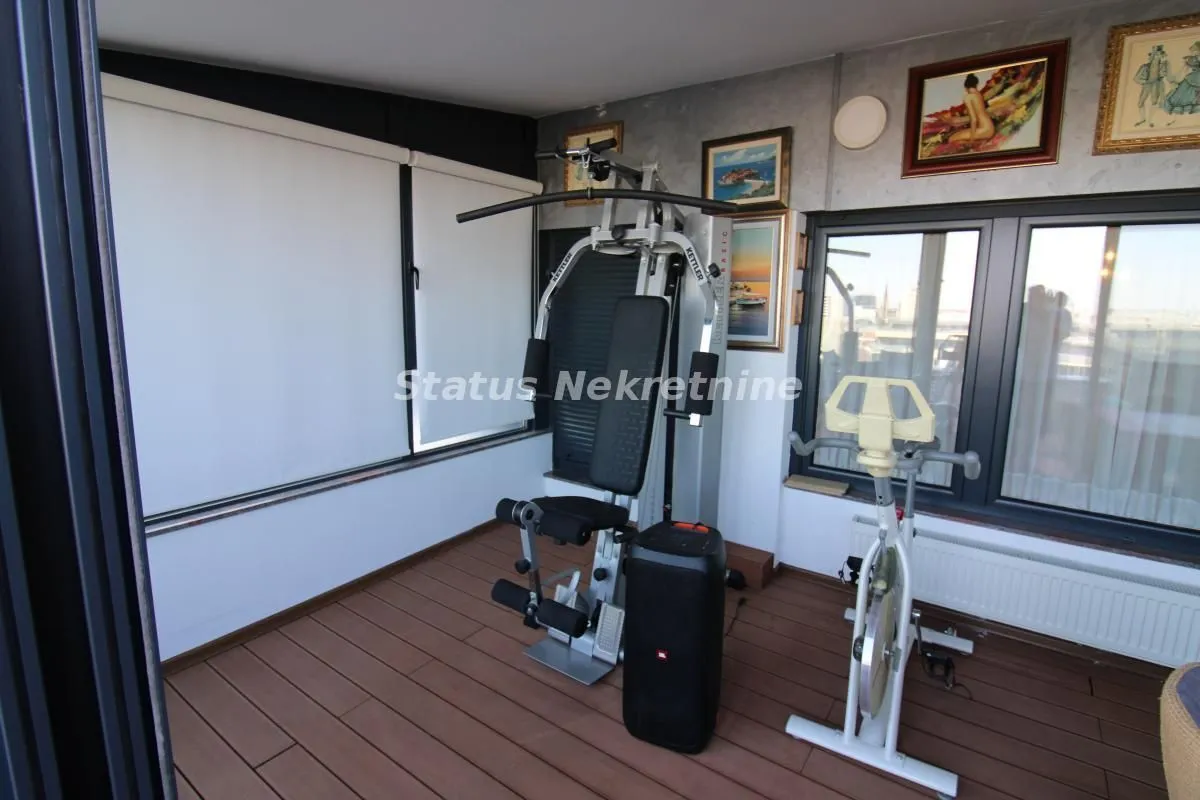 Enclosed terrace with exercise equipment.