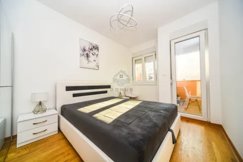 Furnished bedroom with a double bed, bedside table, and access to the terrace. - image 9