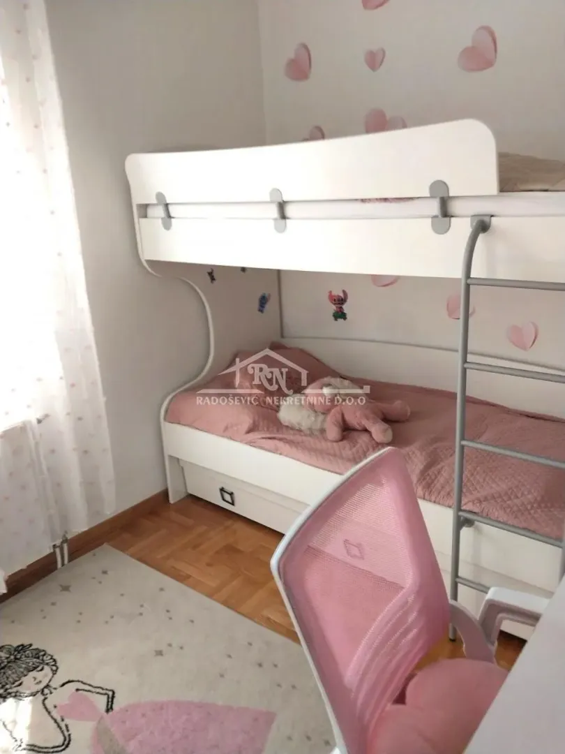 Children's room with a bunk bed and a desk.