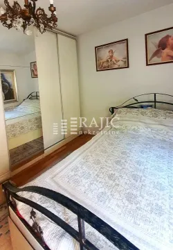 A bedroom with a double bed, mirrored wardrobe, and framed artwork on the wall. - image 7
