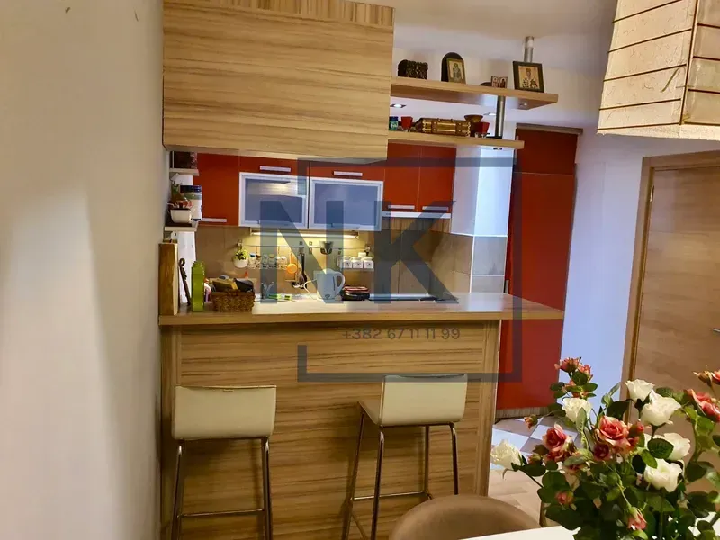 Small kitchen with a breakfast bar and bar stools.