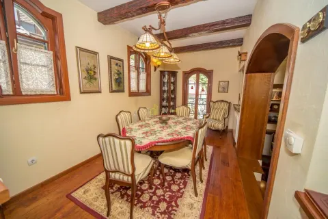 Dining room with wooden furniture and ceiling beams in a rustic style. - image 41