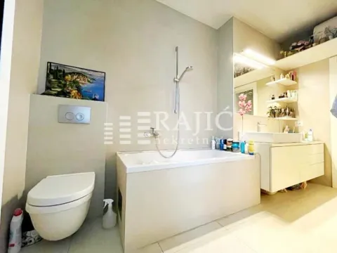 Modern bathroom equipped with a bathtub, toilet, and sink. - image 12