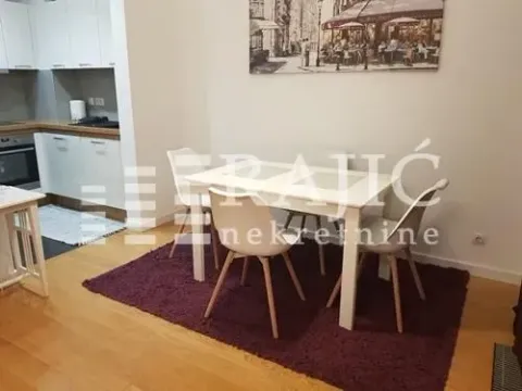 Dining area with a white table and chairs connected to the kitchen. - image 6