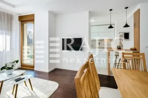 Living room with dining area and kitchen in the background. - image 2