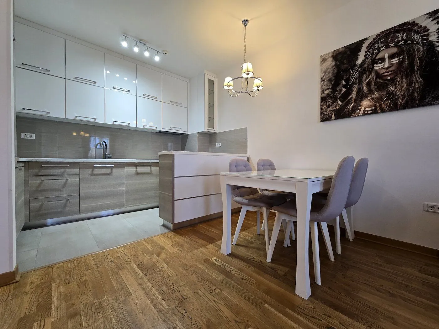 Modern kitchen with a dining area and built-in appliances.