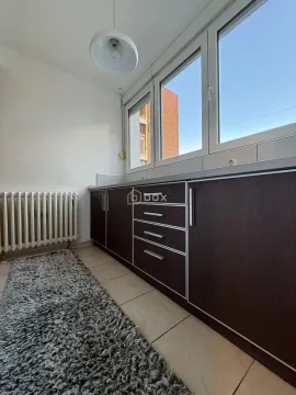 Small kitchen with dark cabinets and a window. - image 9