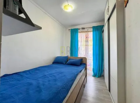 Furnished bedroom with a bed and wardrobe. - image 8