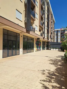 Exterior of a residential and commercial building with a paved plateau on the ground floor. - image 3