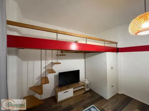 Small bedroom with a loft bed, staircase, and a TV. - image 4