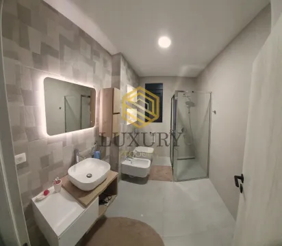 Modern bathroom with a sink, shower cabin, and sanitary fixtures. - image 11