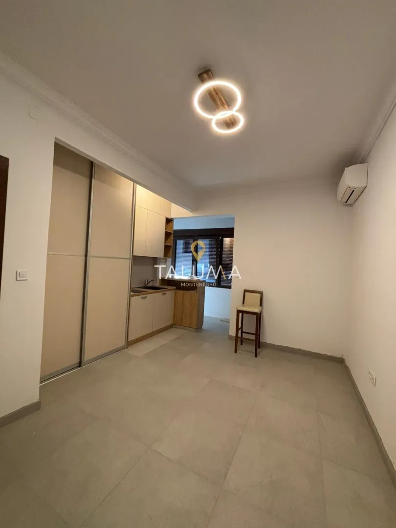 Smaller kitchen with built-in cabinetry and a single bar stool.