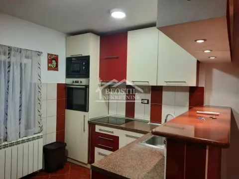 Smaller kitchen with a bar counter and built-in elements in red and white. - image 4