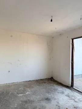 Unfurnished room in poor condition with bare walls and a concrete floor. - image 13