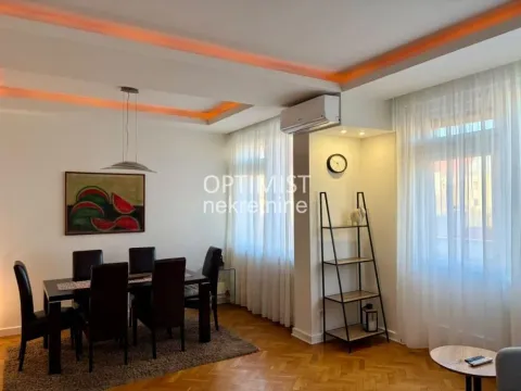 Living room with a dining area and parquet flooring. - image 9