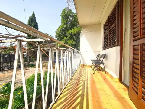 Bright long terrace with a metal railing and a view of the yard. - image 9