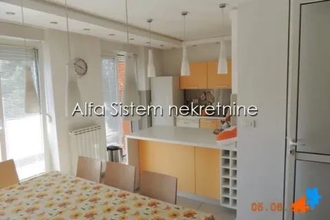 Kitchen with dining area and orange cabinets. - image 25