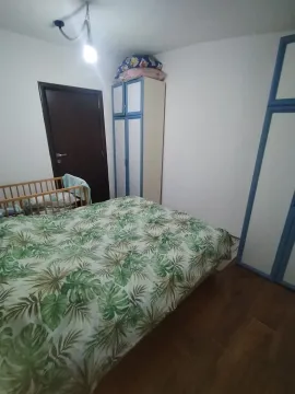 Bedroom with a double bed, wardrobe, and a baby cot. - image 2
