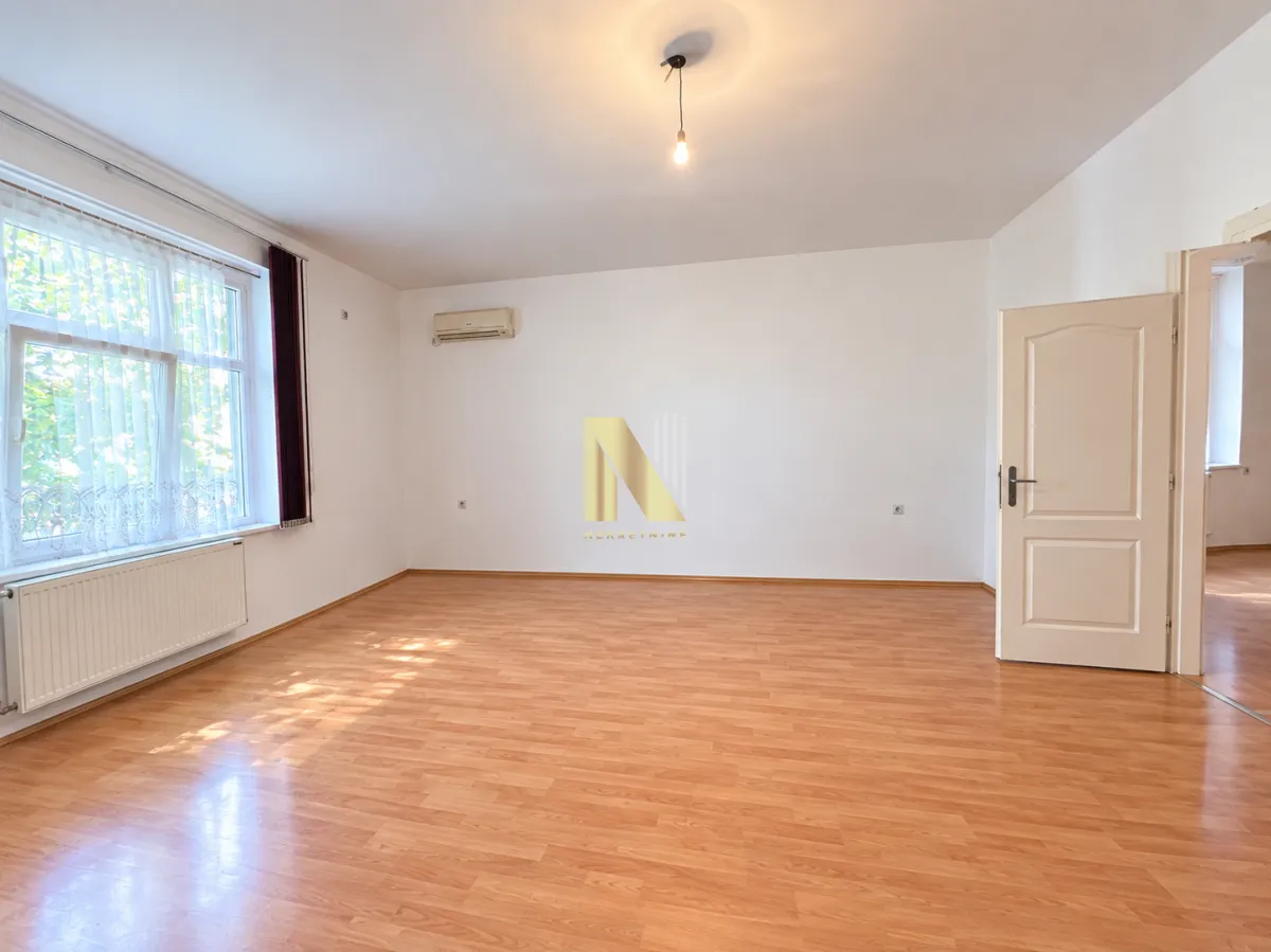 Empty room with laminate flooring and white walls.