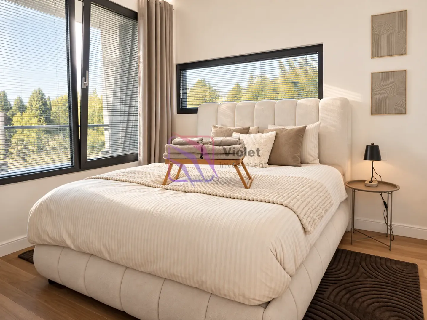 Modern bedroom with a double bed, large window, and green views.
