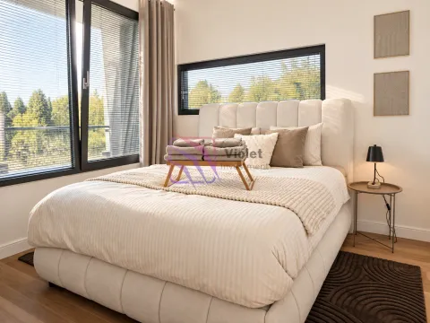 Modern bedroom with a double bed, large window, and green views. - image 8