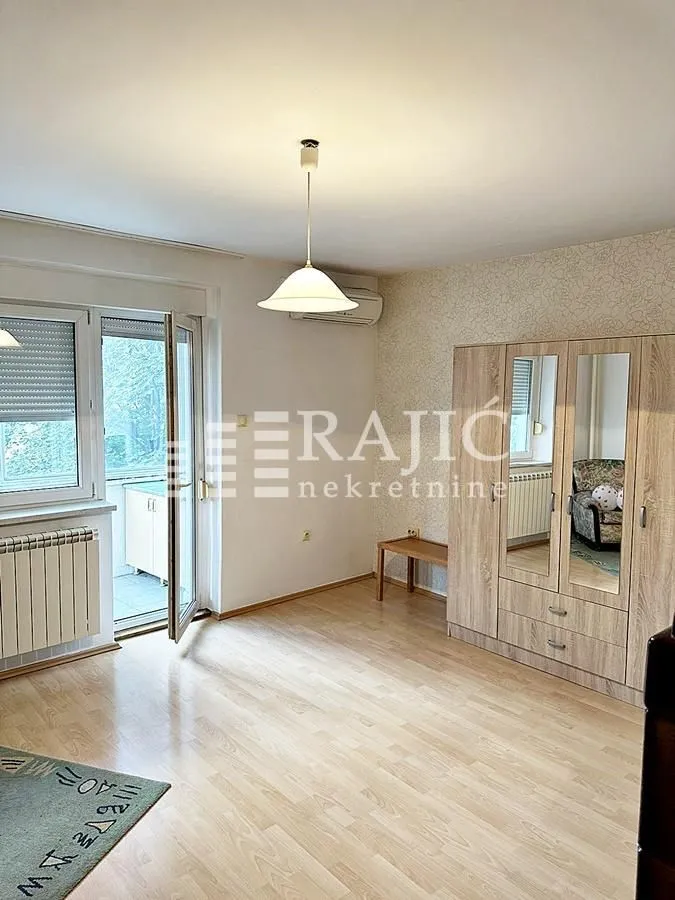 Furnished bedroom with a wardrobe and terrace access.