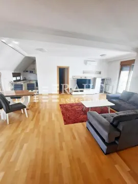 Spacious living room with a dining area and kitchen in the background. - image 11