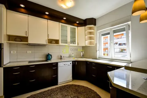 Kitchen with dark and light cabinetry and a window. - image 12