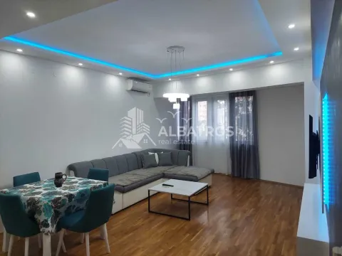 Living room with a sofa set, dining table, and dropped ceiling with lighting. - image 3