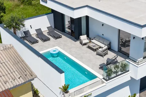 High-angle view of a terrace with a swimming pool and sun loungers. - image 3
