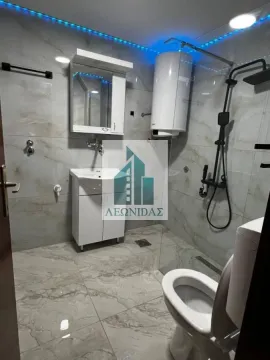 Modernly equipped bathroom with a shower cabin, washbasin, and water heater. - image 13