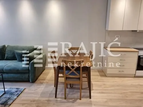Living room with dining area and kitchen in an open space layout.