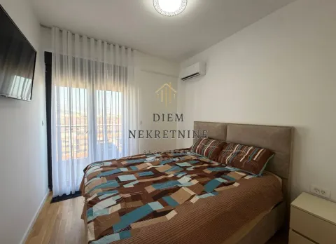 Furnished bedroom with a double bed and balcony access. - image 10